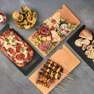 Pizza, skewers, and charcuterie served on Elihome Camper Series boards on an outdoor table