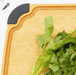 Close-up of an Elihome wood fiber cutting board with color-coded gray silicone corner for vegetables, featuring deep juice groove, shown with fresh celery