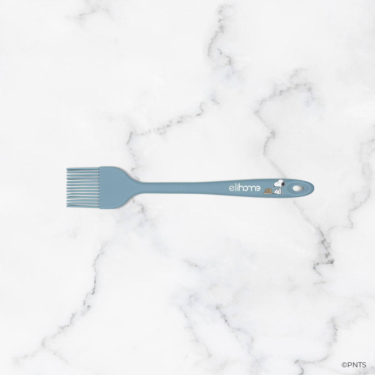 Green spatula with 'elihome' branding on a marble background