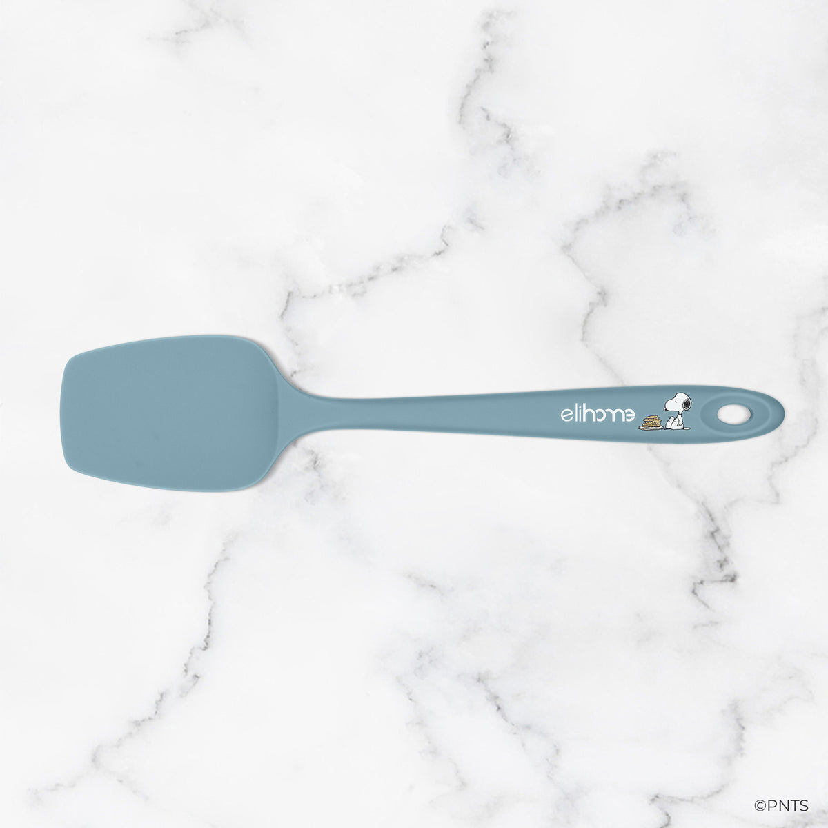 Blue spatula with a brand logo on a marble background