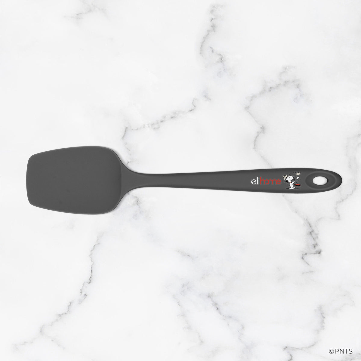 Black spatula with a brand logo on a marble background