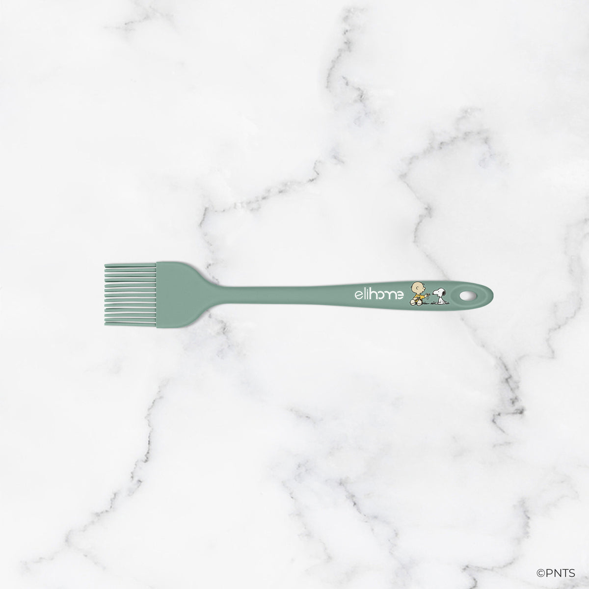 Green spatula with 'elihome' branding on a marble background