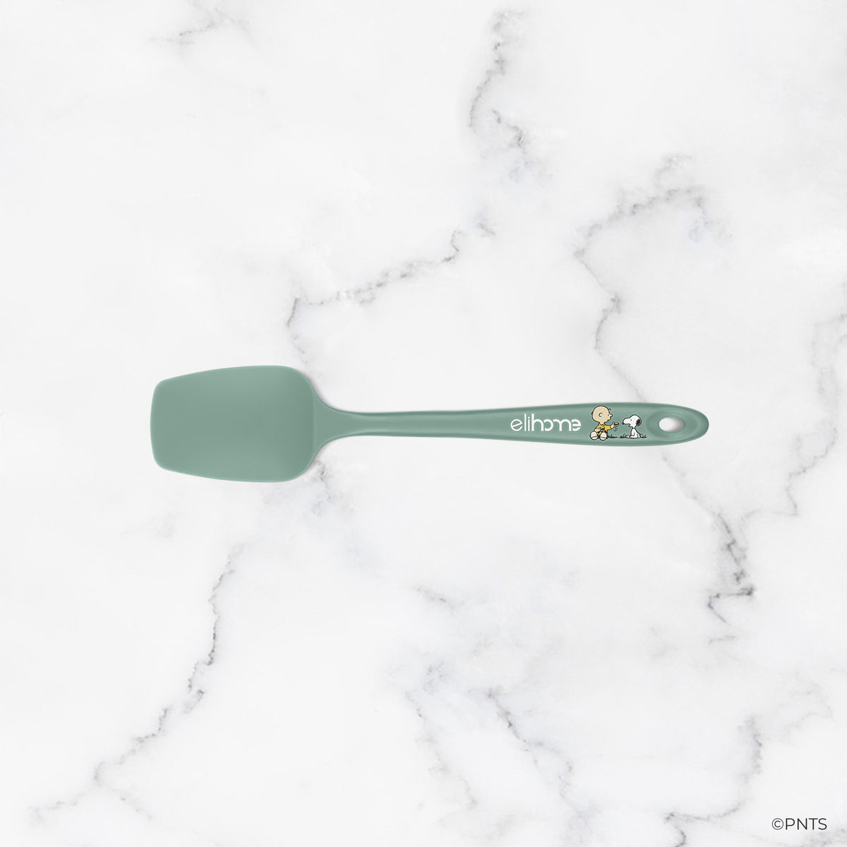 Green spatula on a marble background