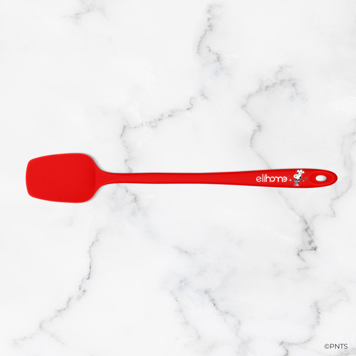 Red spatula with a brand logo on a white marble background