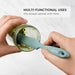 Hands using an Elihome Tiffany Blue skinny silicone spatula to scrape green sauce from a jar, demonstrating its versatility.
